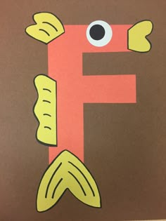 the letter f is made out of paper with an image of a fish on it