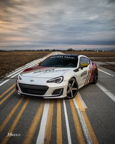 a white sports car parked on the road