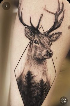 a deer tattoo on the thigh with an arrow in it's head and triangles around its antlers