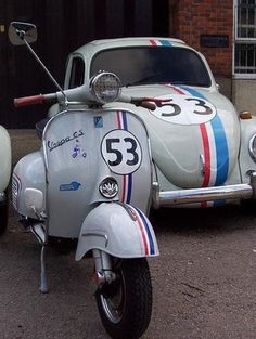 an old vw bug is parked in front of a car with the number 35 painted on it