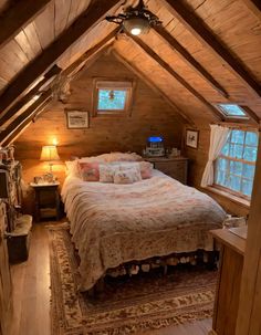 an attic bedroom with wooden walls and ceilings