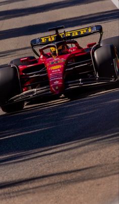 a man driving a racing car down a race track