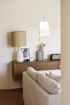 a living room with a couch, table and lamp