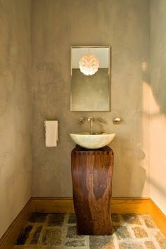 a bathroom with a sink and mirror in it