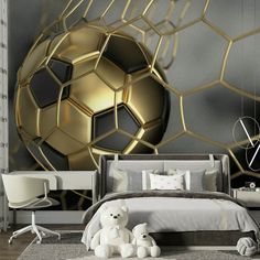 a bedroom decorated in gold and silver with a soccer ball on the wall behind it