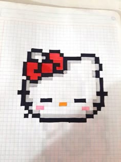 an image of a hello kitty drawn in pixel art style on paper with pen and marker