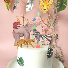 a white cake topped with animals and decorations