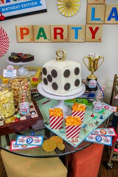 a birthday party with cake, popcorn and other snacks