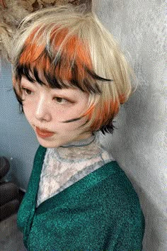 The hairstyle on display mixes up a daring combination of hues, sporting bold orange streaks calling to mind a fox's burning fur, contrasted with natural black roots and bright golden highlights. The style is a funky bob, with choppy sections that give texture and motion, joined by short, piece-y bangs that frame the face in a - Click to see more of Get a Playful Edge with These 33 Foxy Hair Tips and Ideas and follow us for more hairstyle ideas. // Photo Credit: Instagram @nanami__hair Black Hair With Orange Tips, Fun Hair Colour Ideas, Peek A Boo Bangs, Orange Hair With Black Tips, Fox Tip Hair, Orange Hair Tips, Funky Bangs, Orange Highlights In Black Hair, Tip Dyed Hair