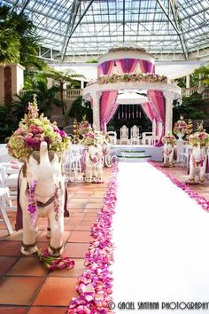 an indoor wedding venue decorated with pink and white flowers