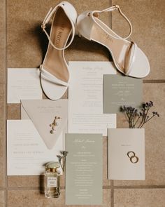 the wedding stationery is laid out on the floor