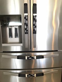 two stainless steel refrigerators side by side with water dispensers on them