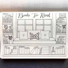 a drawing of a couch with pillows and books on the shelf in front of it