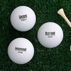 three golf balls and a tee on the grass