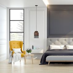 a modern bedroom with gray walls and white bedding, yellow chair and side table