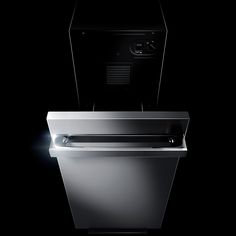 an empty dishwasher in the dark with light coming from it's top