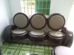 a set of four chairs sitting on top of a tiled floor next to a window