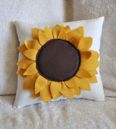 a sunflower pillow on a bed with the words pattern written in black and white