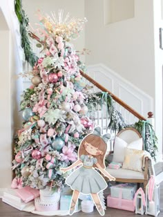 a christmas tree decorated with pastel colors and paper doll standing in front of it