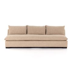 a beige couch sitting on top of a white floor