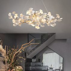 a chandelier hanging from the ceiling in a living room with flowers on it