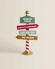 a street sign with many different signs on it's pole and the words north pole santa's workshop ho - ho my room