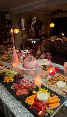 a table filled with lots of food and candles