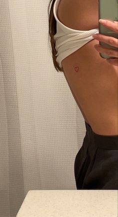 Red tattoo ink, red heart outline, small back tattoo Heart Tattoo On Back, Red Heart Tattoo, Word Tattoo Ideas, Red Heart Tattoos, Tattoo On Back, Tattoos Inspo, Magic Runes, Word Tattoo