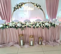 the table is set up with candles and flowers on it for a wedding reception or special event