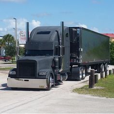 a semi truck parked on the side of the road