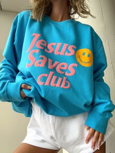 Embrace your faith with the Jesus Saves Club sweatshirt. Made of a soft, cotton blend, this blue crewneck features a 3d puff print light pink graphic that boldly proclaims the message of salvation. Stay comfortable and stylish while spreading the inspiring message of hope. Trendy Blue Graphic Print Sweatshirt, Wwjd Hwlf Sweatshirt, Jesus Crewneck, Light Blue Crew Neck T-shirt With Text Print, Faith Based Sweatshirts, Blue Crewneck, Inspiring Message, Puff Print, Club Sweatshirts