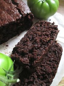 there is a piece of chocolate cake next to some green tomatoes