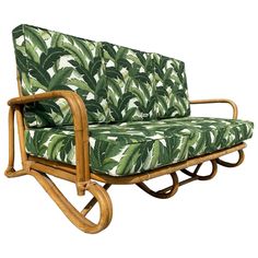 a green and white couch sitting on top of a wooden frame