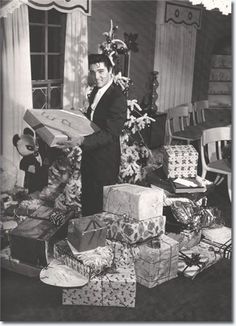 an old black and white photo of a man surrounded by dead animals