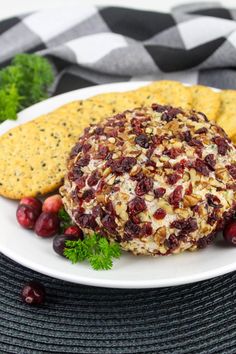 a plate with crackers and cranberry cheese ball on it