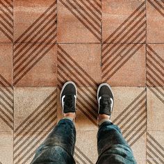 a person standing on top of a tiled floor