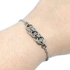 "This bracelet is made with a section of the Helm chain chainmaille weave, done in super shiny stainless steel jump rings. Helm is an incredibly versatile chainmaille weave and is one of my most popular styles. It looks great alone as it is, paired with other bracelets for a stacked looked, or even with with charms attached! Also can make a great anklet! You can find all my Helm weave items here: https://www.etsy.com/shop/ZenJumpsChainmaille?search_query=helm Specifications ●Weave: Helm ●Materia Chainmaille Jewelry Patterns, Chain Maille Patterns, Jump Ring Jewelry, Chainmail Bracelet, Chainmail Jewelry, Chain Maille Jewelry, Popular Styles, Minimalist Bracelet, Chain Anklet