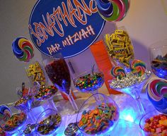 a table topped with lots of candy and lollipops