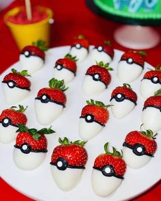 a white plate topped with chocolate covered strawberries and pokemon pikachu cheeses