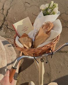 a basket full of food sitting on the back of a bike