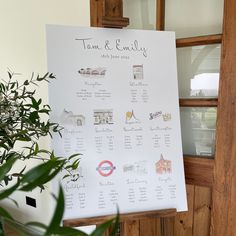 a white sign sitting on the side of a wooden door next to a potted plant