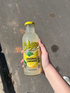 someone holding up a bottle of calories lemonade