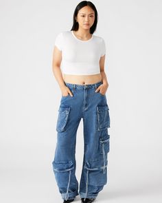 Expertly designed for a structured and voluminous fit, the DUO medium denim pant is crafted from midweight cotton twill fabric. With adjustable ankle straps, these wide leg cargo pants offer a versatile silhouette that can be easily customized to your preference. Mid rise cargo pants Zipper fly with shank button closure Two side pockets, two back patch pockets, and five cargo pockets down the legs Bottom 3 cargo pockets feature extended zipper pulls Snap strap at hem to cinch ankles Inseam: 31" Utility Style Cotton Flare Jeans With Belt Loops, Denim Parachute Pants With Cargo Pockets, Denim Wide-leg Pants With Cargo Pockets, Utility Style Cotton Flare Jeans With Multiple Pockets, Utility Cotton Flare Jeans With Multiple Pockets, Utility Wide-leg Denim Bottoms, Utility Style Cargo Pants With Cropped Leg, Utility Style Wide-leg Denim Bottoms, Utility Style Cropped Cargo Pants With Belt Loops