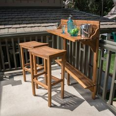 three wooden stools sitting on top of a balcony next to a table and chairs