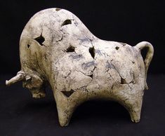 a sculpture of a cow with holes in it's body