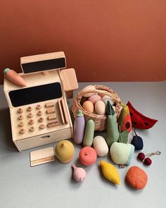 an old fashioned toy cash register surrounded by other toys