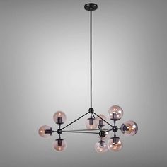 a black chandelier with eight clear globes hanging from it's center