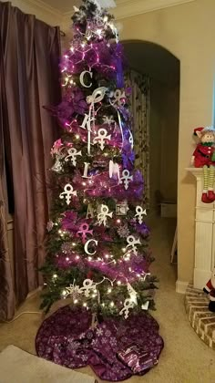 a decorated christmas tree with purple and silver decorations