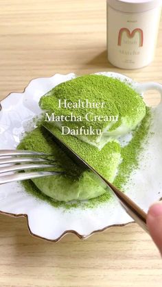 a person is holding a fork over some green powder on a plate with the words healthier matcha cream daifuk