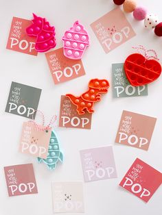 several different types of valentine's day pop cards on a table with hearts and bunting